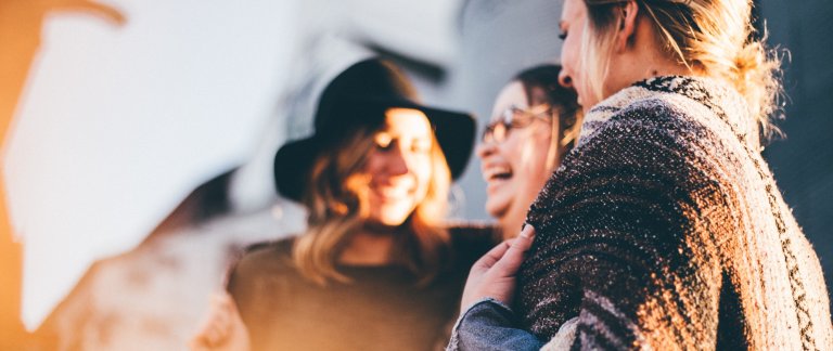 3 women smiling and laughing.